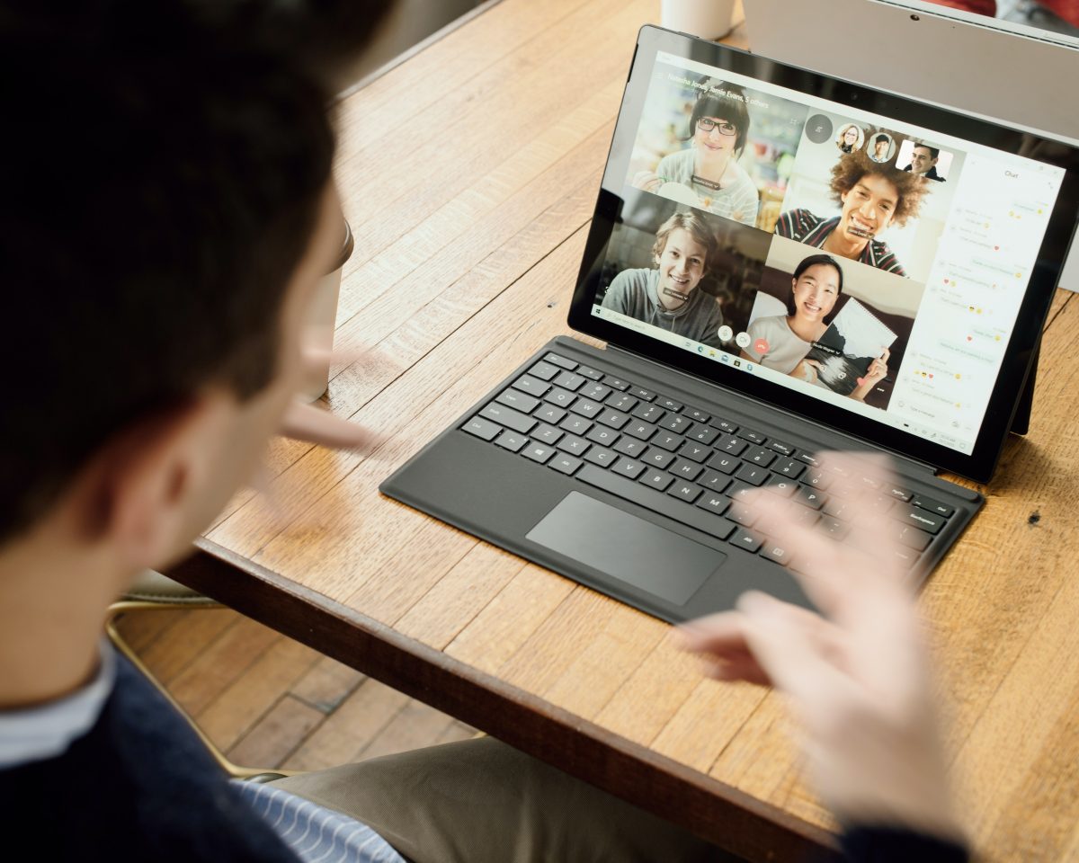 man working remotely in front of a laptop