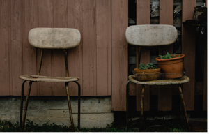 Two chairs with one carrying two pots