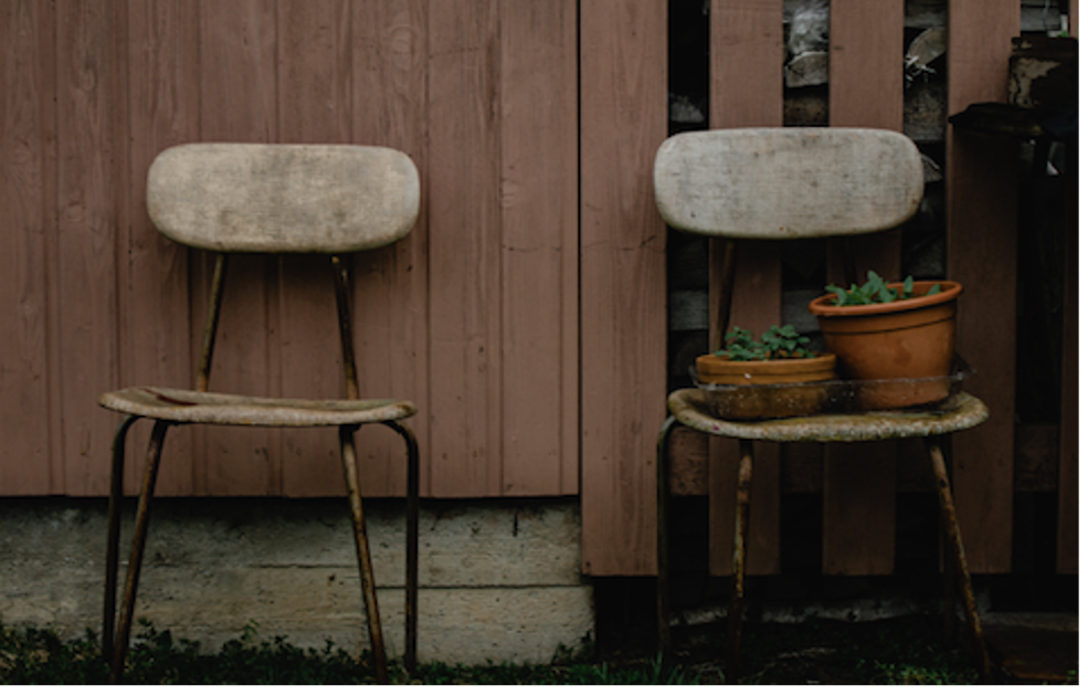 Two chairs with one carrying two pots