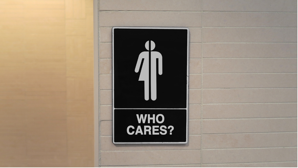 Bathroom sign that says "who cares?"